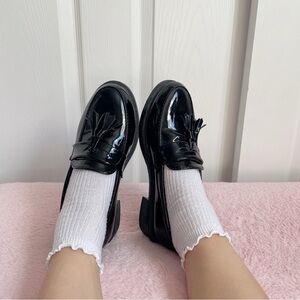 Black patent tassel loafers